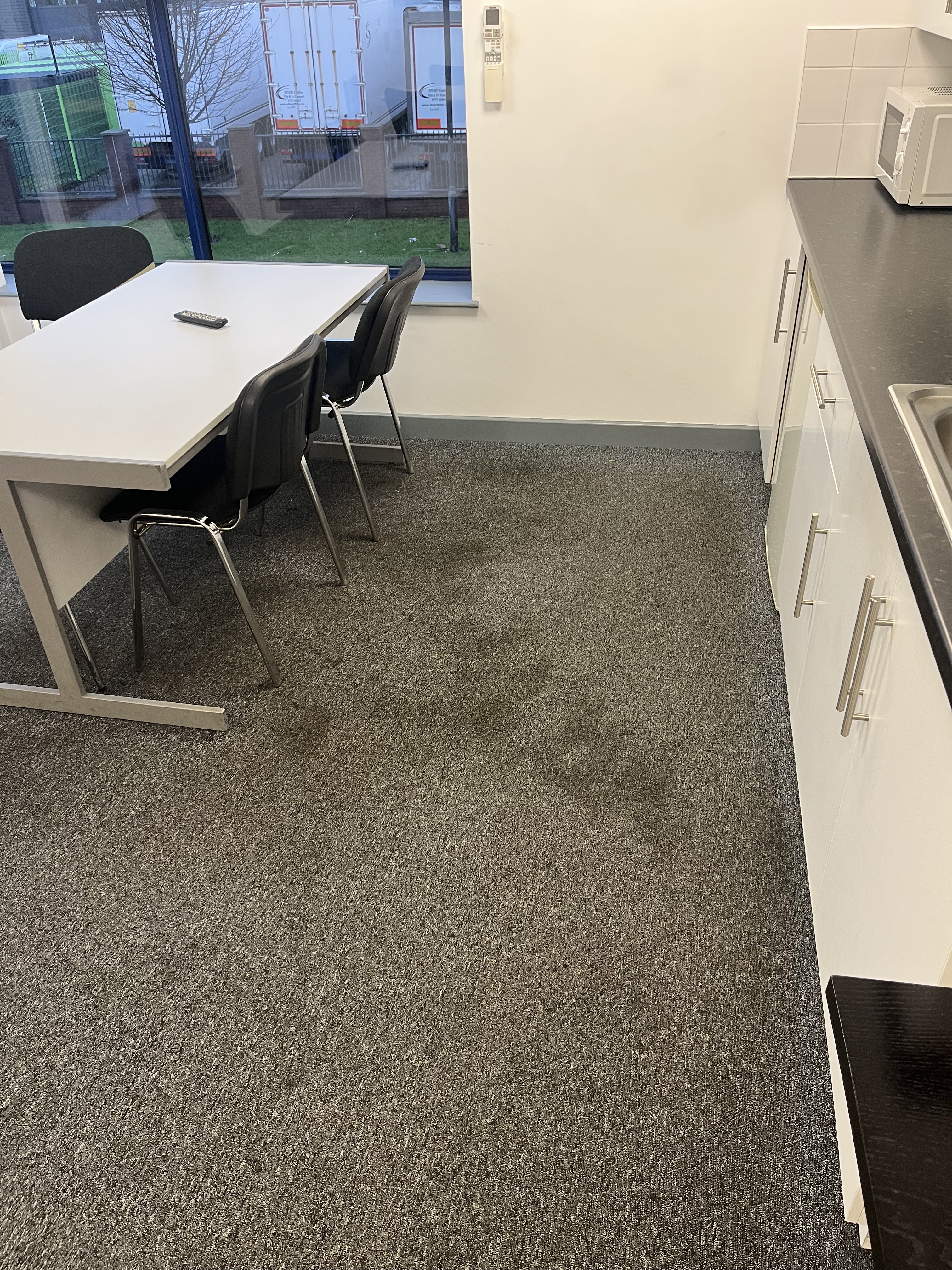 Commercial carpet cleaning in an office kitchen area
